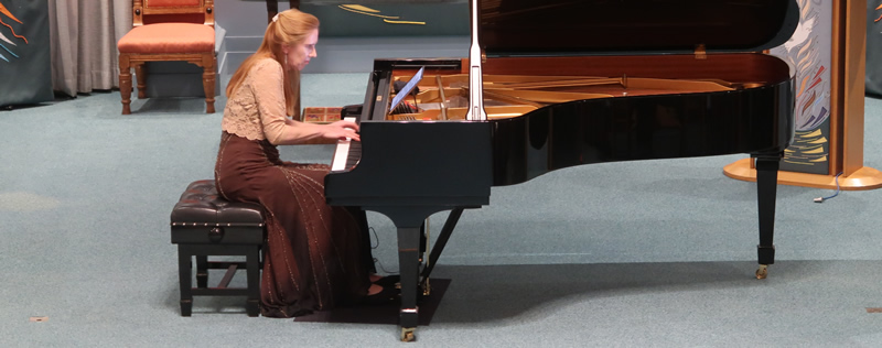 Sarah Beth Briggs playing a grand piano